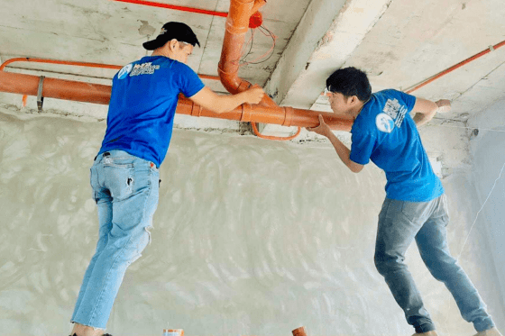 Emergency commercial plumbing repair of a burst pipe in an office building, highlighting rapid response services